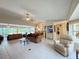 Bright open-concept living room featuring tile floors, ceiling fans, and comfortable seating at 5714 Garden Lakes Fern, Bradenton, FL 34203