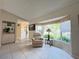 Cozy sitting area with large bay window, built-in shelving, and tile flooring at 5714 Garden Lakes Fern, Bradenton, FL 34203