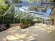 Spacious screened patio with decorative landscaping creates a seamless transition between indoor and outdoor living at 5714 Garden Lakes Fern, Bradenton, FL 34203