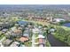 Community aerial view of residences nestled along a scenic golf course and waterways at 6114 Misty Oaks St, Sarasota, FL 34243