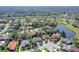 Aerial view of a property near a lake, showcased in a well-established community at 6114 Misty Oaks St, Sarasota, FL 34243