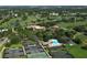 Gorgeous aerial view of the community, including a golf course, clubhouse, tennis courts, and pool at 6114 Misty Oaks St, Sarasota, FL 34243