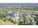 Aerial view of a community showcasing well-maintained homes, mature trees, and waterfront properties at 6114 Misty Oaks St, Sarasota, FL 34243