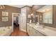 Bathroom features dual sinks, granite countertops, walk-in shower, soaking tub and an adjacent walk-in closet at 6114 Misty Oaks St, Sarasota, FL 34243