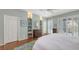 Light and airy bedroom features shutters, hardwood floors and decorative built-in shelving at 6114 Misty Oaks St, Sarasota, FL 34243