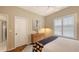 Well-lit bedroom with shutters, artwork, and a ceiling fan at 6114 Misty Oaks St, Sarasota, FL 34243