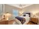 Cozy bedroom with a ceiling fan, window shutters, and comfortable furnishings for a restful retreat at 6114 Misty Oaks St, Sarasota, FL 34243