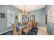 Charming dining room offers ample seating, a decorative chandelier, and a serene atmosphere at 6114 Misty Oaks St, Sarasota, FL 34243