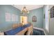 Dining room with table and chairs, with decorative chandelier and a wall of decorative wall-art at 6114 Misty Oaks St, Sarasota, FL 34243