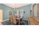 Formal dining room with a blue accent wall and decorative lighting at 6114 Misty Oaks St, Sarasota, FL 34243