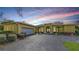 Charming single Gathering home with a two-car garage, arched entrance, and neatly landscaped yard at 6114 Misty Oaks St, Sarasota, FL 34243