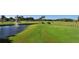 Golf course view of putting green, picturesque water feature and bridge at 6114 Misty Oaks St, Sarasota, FL 34243