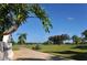 Lush green golf course scenery with palm tree lined fairway and blue sky backdrop at 6114 Misty Oaks St, Sarasota, FL 34243