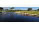 Scenic water view on the golf course, enhanced by a classic fountain at 6114 Misty Oaks St, Sarasota, FL 34243