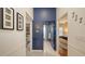 Hallway features decorative blue accent wall leading to bedrooms with en-suite bathrooms and closet at 6114 Misty Oaks St, Sarasota, FL 34243