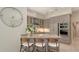 Stylish kitchen featuring a quartz island with barstool seating, stainless steel appliances, and plenty of storage space at 6114 Misty Oaks St, Sarasota, FL 34243