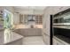 Modern kitchen with stainless steel appliances, ample cabinet space, and a stylish tile backsplash at 6114 Misty Oaks St, Sarasota, FL 34243