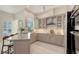 Modern kitchen boasts stainless steel appliances, custom cabinetry, and a spacious island with seating at 6114 Misty Oaks St, Sarasota, FL 34243