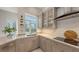 Modern kitchen featuring white cabinets, granite countertops, and stainless steel appliances at 6114 Misty Oaks St, Sarasota, FL 34243