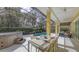 Inviting screened lanai with a dining table set, hot tub, and a view of the sparkling pool at 6114 Misty Oaks St, Sarasota, FL 34243