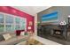 Cozy living room showcases a fireplace, built-ins, and large windows with plantation shutters at 6114 Misty Oaks St, Sarasota, FL 34243