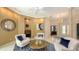 Spacious living room with a chandelier and views of the front entrance and the adjacent office space at 6114 Misty Oaks St, Sarasota, FL 34243