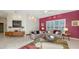 Spacious living room with modern furnishings, including dual sofas and stylish decor at 6114 Misty Oaks St, Sarasota, FL 34243