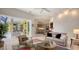 Bright living room features modern furnishings and an open layout with access to an outdoor dining area at 6114 Misty Oaks St, Sarasota, FL 34243