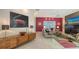 Bright living room with modern decor, large wine-themed art, and decorative fireplace at 6114 Misty Oaks St, Sarasota, FL 34243