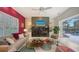Inviting living room featuring a fireplace, comfortable seating, and sliding glass doors to the patio at 6114 Misty Oaks St, Sarasota, FL 34243