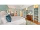 This spacious main bedroom offers custom built-in shelving and a calming color palette at 6114 Misty Oaks St, Sarasota, FL 34243