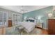 Relaxing main bedroom features a panel accent wall, hardwood floors, and bright natural light at 6114 Misty Oaks St, Sarasota, FL 34243