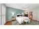 Bright main bedroom includes a panel accent wall, hardwood floors, and an ensuite bathroom at 6114 Misty Oaks St, Sarasota, FL 34243