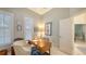 Bright office with shuttered window, wooden desk, and view into the hallway at 6114 Misty Oaks St, Sarasota, FL 34243
