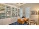 Home office boasts custom built-ins, ample shelving, a ceiling fan, and an inviting workspace at 6114 Misty Oaks St, Sarasota, FL 34243