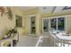Enclosed patio with dining set, sliding glass doors, and views of the outdoor pool area at 6114 Misty Oaks St, Sarasota, FL 34243