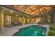 Stunning lanai with a pool, hot tub, covered patio, and expansive views of the sky and garden at 6114 Misty Oaks St, Sarasota, FL 34243