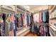 This walk-in closet is designed with rods and shelves to easily organize clothing and accessories at 6114 Misty Oaks St, Sarasota, FL 34243