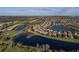 Expansive aerial view of a sprawling residential area with serene lakes, a golf course, and lush landscaping at 6560 Willowshire Way, Bradenton, FL 34212