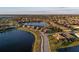 Aerial view of a community featuring lakefront homes, lush landscaping, and serene lakes at 6560 Willowshire Way, Bradenton, FL 34212