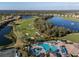 High aerial showcasing golf course, community pool, and beautiful Florida homes with lakes throughout at 6560 Willowshire Way, Bradenton, FL 34212