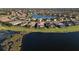 Aerial view of waterfront homes in a well-manicured community with lake views and lush landscaping at 6560 Willowshire Way, Bradenton, FL 34212