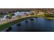 Aerial view of community featuring lakefront properties, lush landscaping, and a serene lake at 6560 Willowshire Way, Bradenton, FL 34212