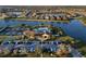 Overhead shot of the pool, clubhouse, tennis courts, and parking area surrounded by lakefront homes at 6560 Willowshire Way, Bradenton, FL 34212