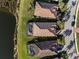 Aerial view of luxury homes with screened pools near a tranquil lake in a sunny residential community at 6560 Willowshire Way, Bradenton, FL 34212
