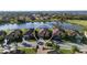 Aerial view of a single-Gathering home near a serene lake, showcasing a beautiful, established neighborhood at 6560 Willowshire Way, Bradenton, FL 34212
