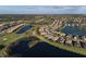Panoramic aerial view of a residential community featuring homes nestled around scenic lakes and a golf course at 6560 Willowshire Way, Bradenton, FL 34212