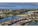 Scenic aerial view of waterfront homes nestled around a golf course and glistening lakes, surrounded by lush greenery at 6560 Willowshire Way, Bradenton, FL 34212