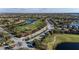 Aerial view of a community featuring lush landscaping, lakes, golf course, and meticulously maintained streets at 6560 Willowshire Way, Bradenton, FL 34212