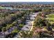 Aerial view of a community featuring lush landscaping, serene lakes, and meticulously maintained streets at 6560 Willowshire Way, Bradenton, FL 34212